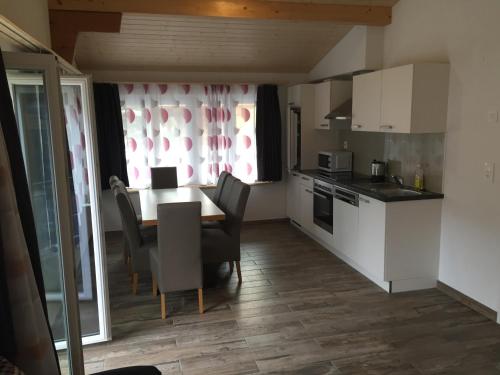 a kitchen with a table and chairs in a room at Swiss Chalet Holidays Ringgenberg in Ringgenberg