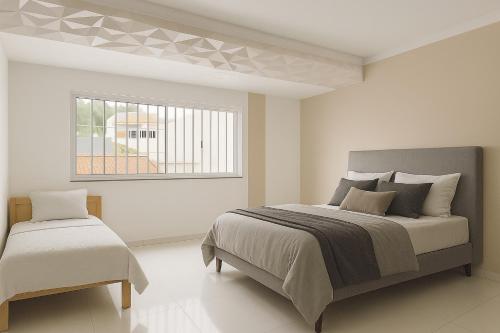 a bedroom with a large bed and a window at Casa para cop 30 in Belém