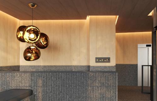 a lobby with two chandeliers on the wall at Kukun Edition Marsella Juarez in Mexico City