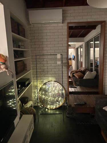 a living room with a mirror and a chair at Shimokitazawa Sanctuary , Spacious Stay for Families & Romantic Getaways in Tokyo