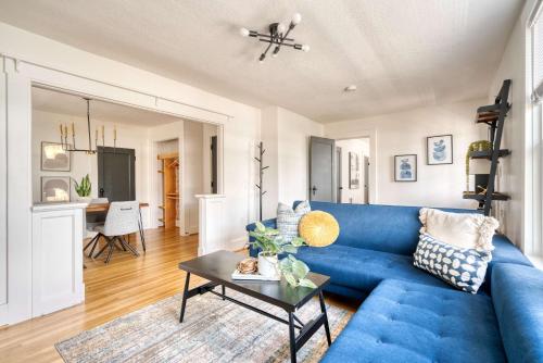 a blue couch in a living room with a table at Stay Portland - La Casa Burnside -Local Eateries -Shops - Bars in Portland