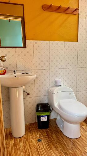 a bathroom with a sink and a toilet at Lia B&B Lucmabamba in Sahuayacu