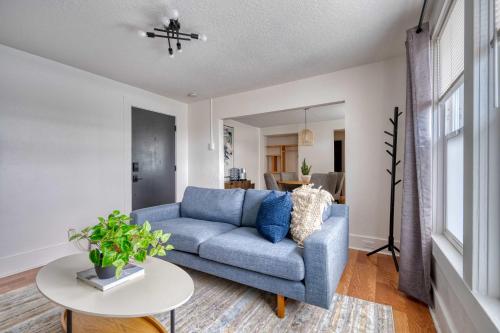 a living room with a blue couch and a table at Stay Portland - La Casa Burnside - Local Eateries, Shops, and Bars in Portland