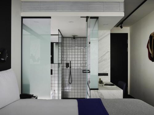 a bedroom with a shower and a bed and a bathroom at Tribe Perth Kings Park in Perth