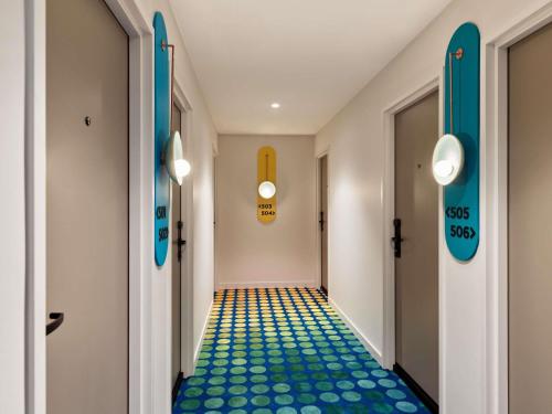 a corridor with blue and yellow flooring in a hallway at The Clarence Hotel Sydney in Sydney