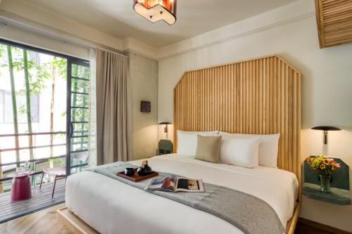 a bedroom with a bed with a book on it at Rodona Hotel in Mexico City