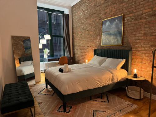 a bedroom with a bed and a brick wall at Top Location - The 777 Old Port Gem in Montreal