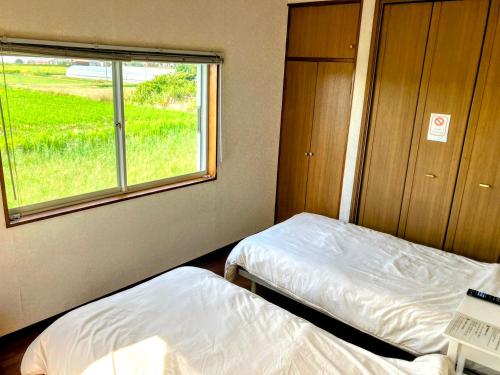 Ένα ή περισσότερα κρεβάτια σε δωμάτιο στο ペットと泊まれる一棟貸し 海の駅九十九里まで徒歩15分 はうす41マイルズ