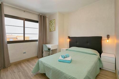 a bedroom with a bed with two towels on it at Cozy apartment in classic style in Playa de San Juan