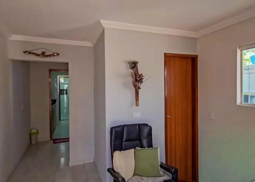 una sedia nera in un soggiorno con finestra di Apartamento Paraíso Lua e Mar - Manoah Beach Flats a Maragogi