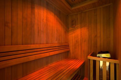 a wooden sauna with a wooden bench in it at Rodona Hotel in Mexico City