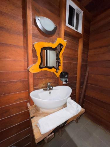 a bathroom with a white sink and a mirror at Hotelito Villas Holbox in Holbox Island