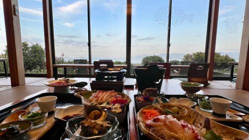 a table with dishes of food on it with a view at Yuinoya MITSUBACHI in Imabari