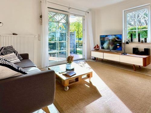 a living room with a couch and a coffee table at Whg Dynamique in Zingst