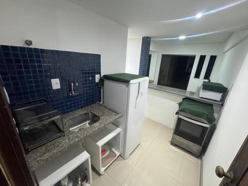a small kitchen with a sink and a counter at Village Pedra do Sal Lounge Apts in Salvador