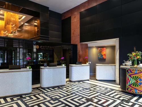 a lobby of a hotel with a reception desk and a lobby at Pullman Cape Town City Centre in Cape Town