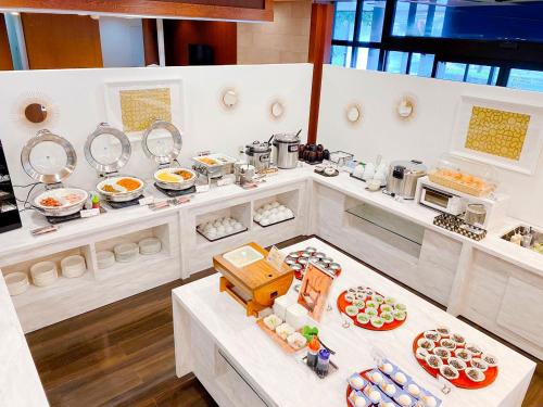 a kitchen with many plates of food on a table at Rembrandt Inn Kazusa in Kimitsu