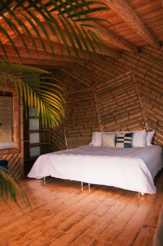 a bedroom with a bed in a wooden room at Hotel PIA Colombia in Marinilla