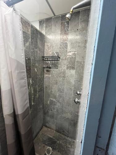 a bathroom with a shower with a glass door at Departamento Azul Roma in Cedro