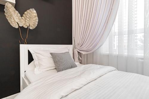 Ένα ή περισσότερα κρεβάτια σε δωμάτιο στο Шикарный Гостевой Guest Аpartments MURAGER