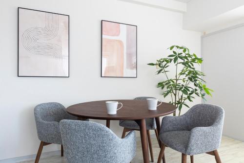 a dining room with a wooden table and two chairs at エドモダンステイ Edo Modern Stay 01 in Tokyo