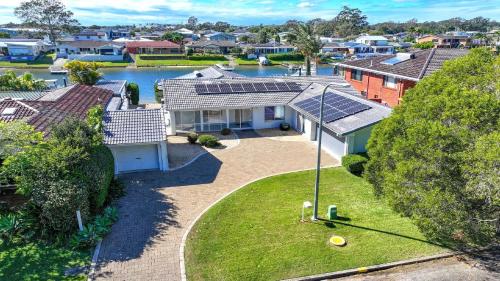 an overhead view of a house with solar panels on it at Hibbard Waterfront Escape in Port Macquarie