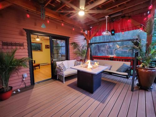 a patio with a couch and a table on a deck at 3 Bedroom 2 Bath, 120 protector, 600MB WIFI in Albany