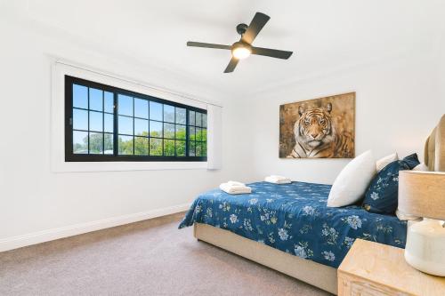 a bedroom with a bed and a ceiling fan at Homestead on Fennell - Fresh Eggs, Farm & BBQ Fun in Toronto