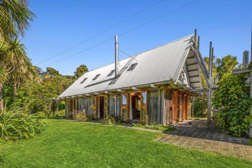 an old house with a metal roof at The Gatehouse - Tata Headlands in Tata Beach