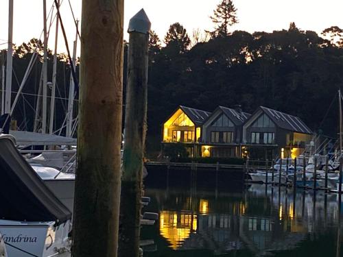 a house in a marina with boats in the water at Luxury Waterfront Marina Apartment - Bay of Islands, New Zealand in Opua