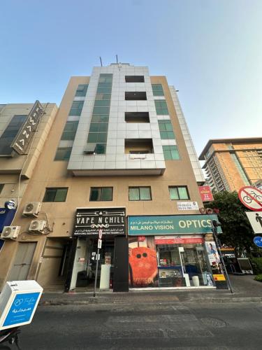 a tall building on a city street with a store at Chill Studio apartments Al rigga Dubai in Dubai