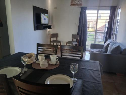 a living room with a table with chairs and a couch at Armonía & Relax in Villa Amelia