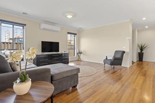 a living room with a couch and a tv at Family Retreat with Garden and Parking in Melbourne