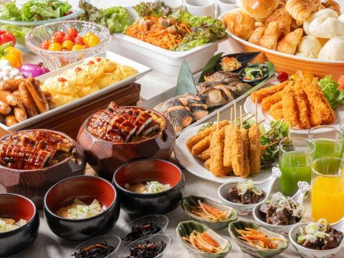 a table topped with lots of different types of food at APA Hotel Nagoya Sakae Ekimae EXCELLENT in Nagoya