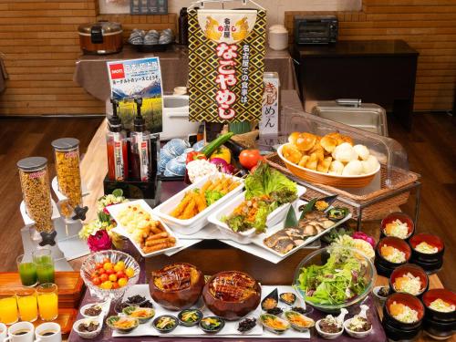 a table filled with different types of food at APA Hotel Nagoya Sakae Ekimae EXCELLENT in Nagoya
