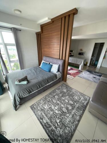a bedroom with a bed with a wooden headboard at TOKAYOH D Khadijah in Kota Bharu
