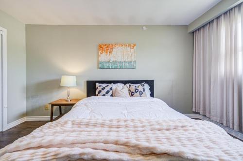 a bedroom with a large bed and a table at Nest in the Orchard--cozy room in Toronto