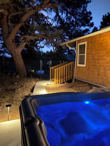 a blue hot tub in front of a house at Hot Tub! Pets Ok! Perfect Estes Park Getaway, Walk to Town 3 Kings!#3337 in Estes Park