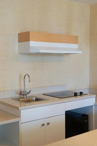 a kitchen with a sink and a microwave at Waikiki Resort Hotel in Honolulu