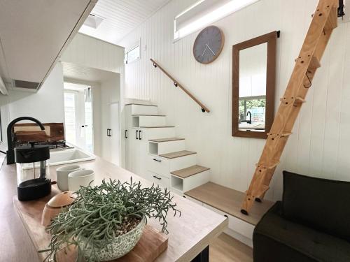 a staircase in a house with a potted plant at Atherton Tiny - Retreat with Fire Pit in Atherton