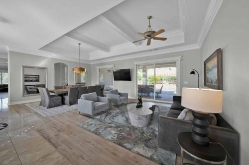 a living room with couches and a ceiling fan at La Rinconada Place in Redding