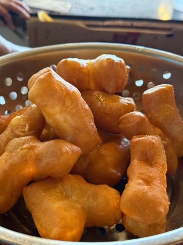 a metal bowl filled with fried food in at Koh Mook Garden Beach Resort in Koh Mook
