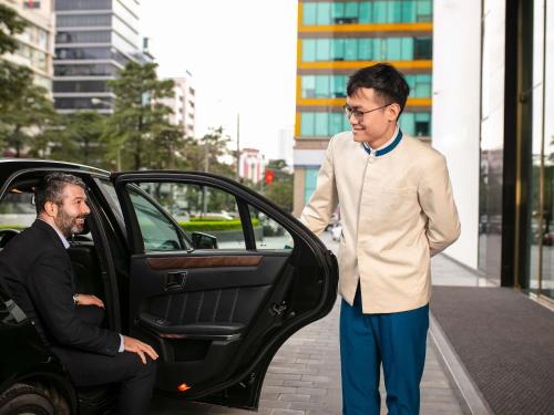 a man is getting out of a car at Mövenpick Living West Hanoi in Hanoi