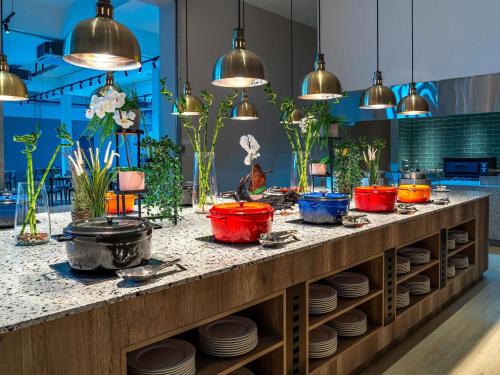 a table with plates and pendant lights at ibis Styles Sepang KLIA in Sepang