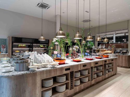 a kitchen with a buffet with plates and bowls at ibis Styles Sepang KLIA in Sepang