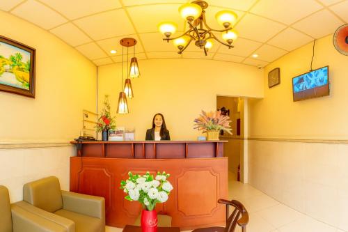 a woman standing at a waiting room in a waiting room practition at Cát Tường Hotel in Ho Chi Minh City