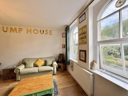 a living room with a couch and a table at Flat 2, Waterloo Apartments in Radstock