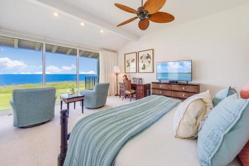 a bedroom with a bed with a television and a desk at Kapalua Bay Villas 35G1 · KBV 35G1 Luxury Kapalua Villa w AC Poo in Kahana
