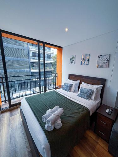 En eller flere senge i et værelse på Increíble apartamento - Taj Bogotá Chico