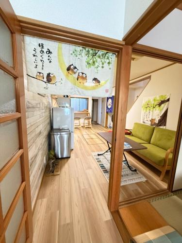 a living room with a couch and a table at Ume-no-Yado Villa 梅の宿 - A house with a traditional Japanese garden in Osaka